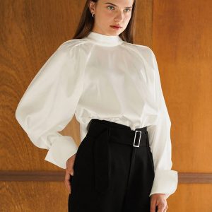CopyIvory-colored high-necked shirt with sculpted shoulders